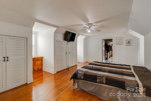 bedroom with vaulted ceiling, hardwood / wood-style floors, and ceiling fan