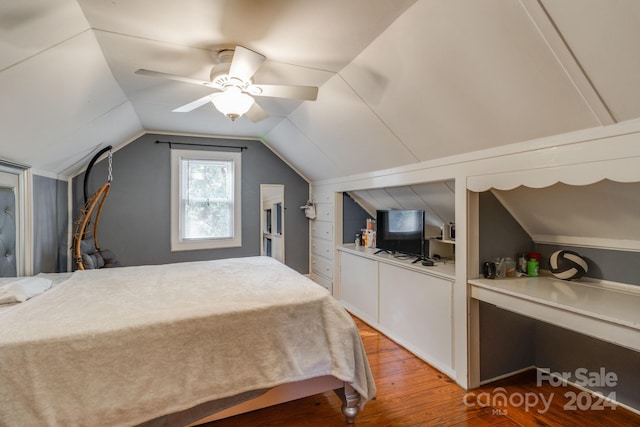 bedroom featuring wood-type flooring, vaulted ceiling, and ceiling fan