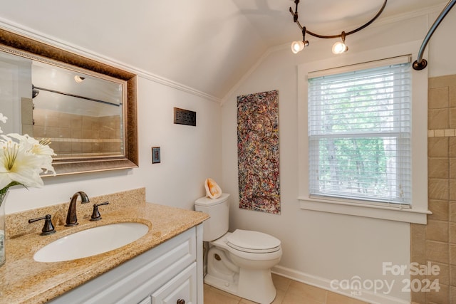 bathroom featuring vanity, lofted ceiling, ornamental molding, toilet, and tile patterned floors