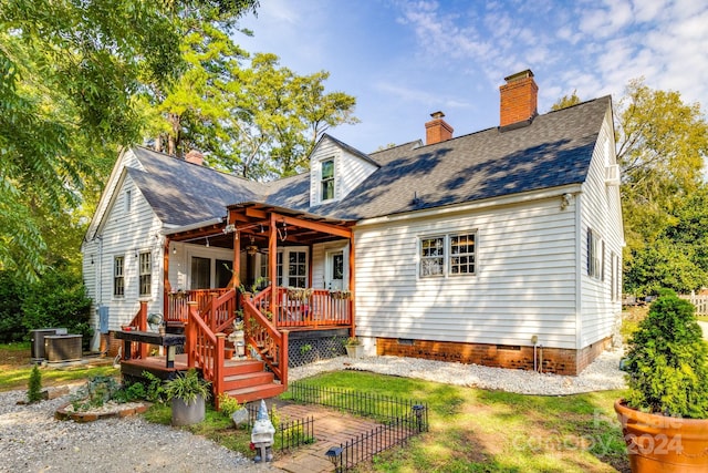 rear view of house with a wooden deck