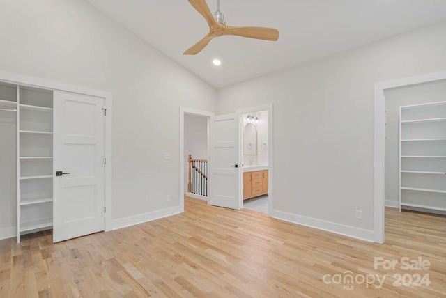 unfurnished bedroom featuring ensuite bathroom, ceiling fan, high vaulted ceiling, light hardwood / wood-style floors, and a closet