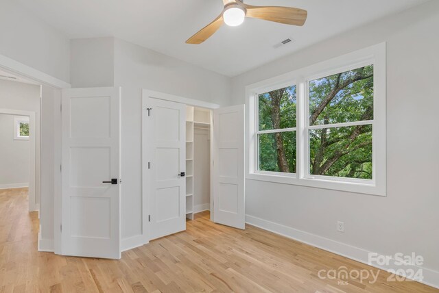 345 Riverview Dr, Asheville, NC 28806 - unfurnished bedroom with baseboards, visible vents, a ceiling fan, and light wood finished floors