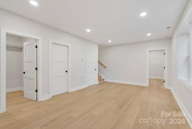 345 Riverview Dr, Asheville, NC 28806 - basement featuring stairway, visible vents, recessed lighting, and light wood finished floors