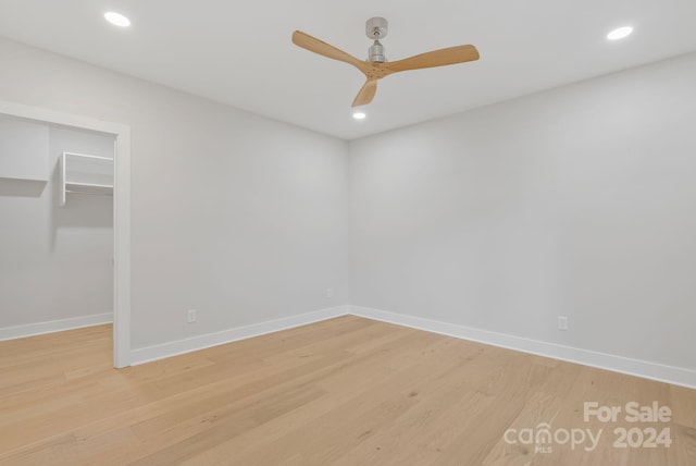 empty room with light wood-type flooring and ceiling fan