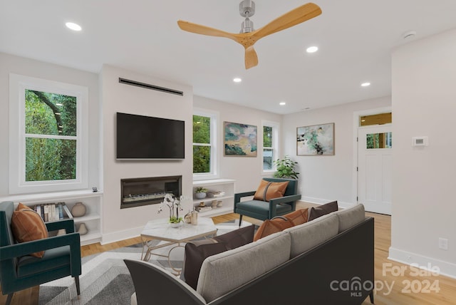 345 Riverview Dr, Asheville, NC 28806 - living area with recessed lighting, a glass covered fireplace, baseboards, light wood-type flooring, and a ceiling fan