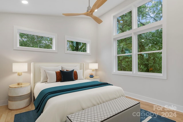 bedroom with wood-type flooring, ceiling fan, and lofted ceiling