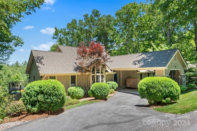 single story home featuring a carport