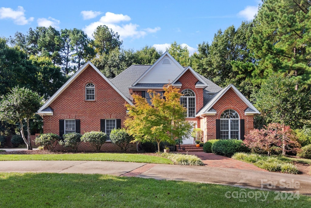 1408 Stone Gate Dr, Shelby, NC 28150 - view of front of house featuring brick siding, a front lawn, and a shingled roof