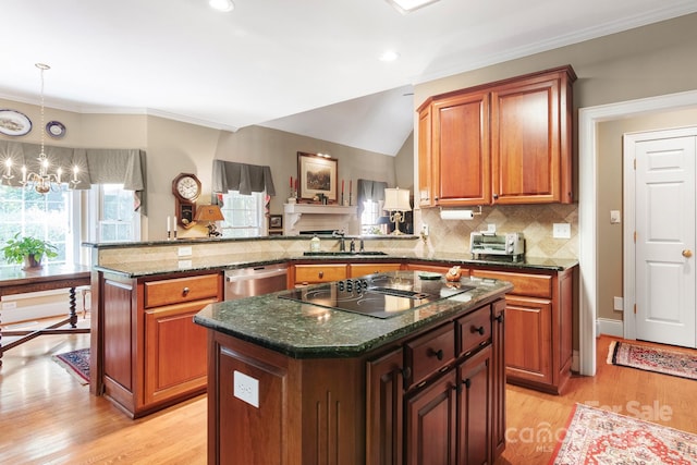 kitchen with a kitchen island, an inviting chandelier, dishwasher, light hardwood / wood-style floors, and kitchen peninsula