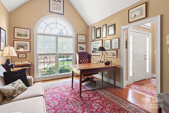 office featuring high vaulted ceiling and hardwood / wood-style floors