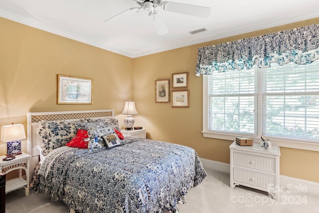 bedroom featuring ceiling fan, ornamental molding, and carpet floors