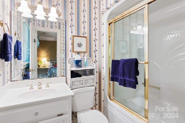 full bathroom with vanity, toilet, and combined bath / shower with glass door