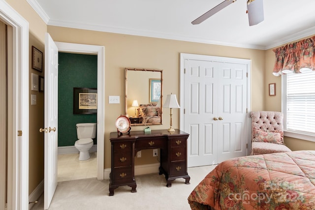 carpeted bedroom featuring ornamental molding, ceiling fan, and a closet