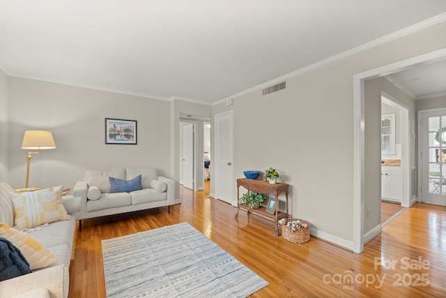 living room with crown molding and hardwood / wood-style floors