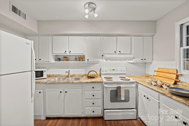 kitchen featuring sink, white cabinetry, dark hardwood / wood-style floors, white appliances, and decorative backsplash