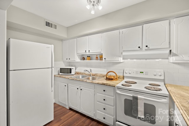 kitchen with dark wood-type flooring, sink, white cabinets, white appliances, and backsplash