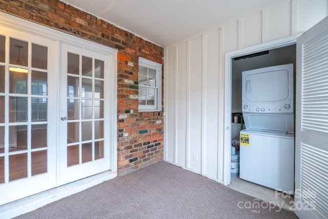 interior space with french doors and stacked washer and dryer