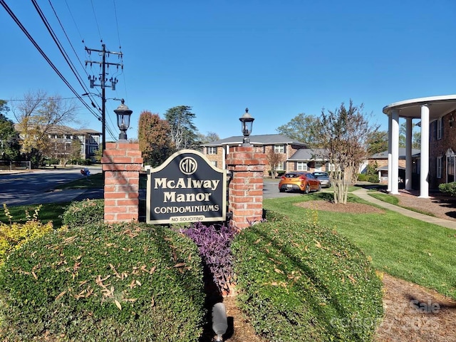 community / neighborhood sign with a yard