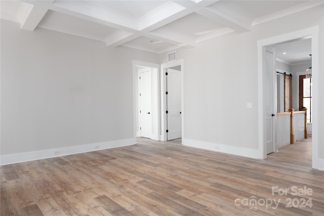 unfurnished room featuring crown molding, coffered ceiling, light hardwood / wood-style floors, and beam ceiling