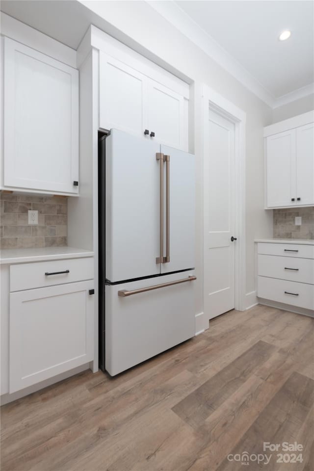 kitchen featuring light hardwood / wood-style floors, backsplash, white cabinets, and high end fridge