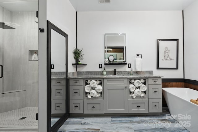 bathroom featuring vanity and shower with separate bathtub