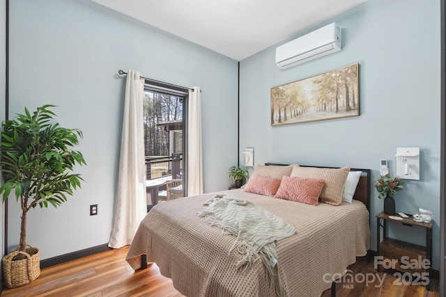 bedroom featuring a wall mounted AC and light hardwood / wood-style flooring