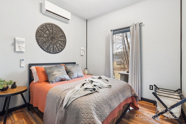 bedroom featuring dark hardwood / wood-style flooring and a wall mounted AC