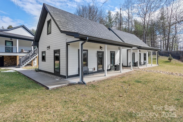 back of property with a yard and a patio