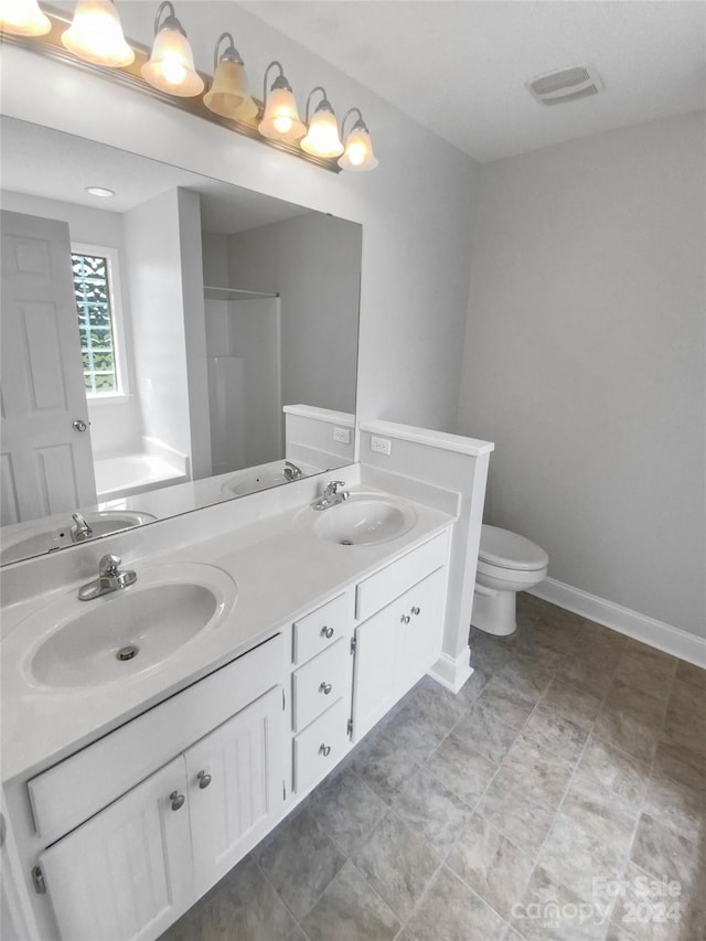 full bathroom featuring separate shower and tub, toilet, and vanity