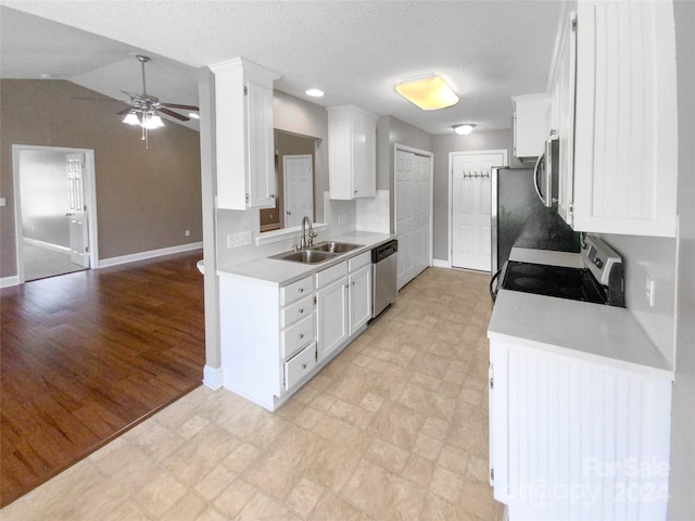 kitchen featuring light hardwood / wood-style flooring, stainless steel appliances, sink, lofted ceiling, and ceiling fan