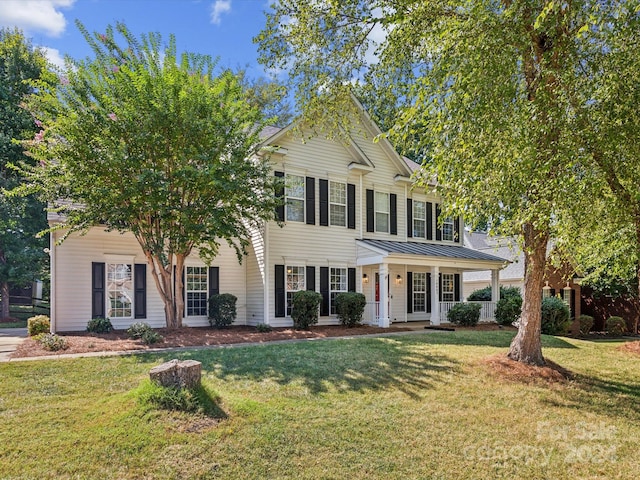 view of front of property with a porch and a front lawn