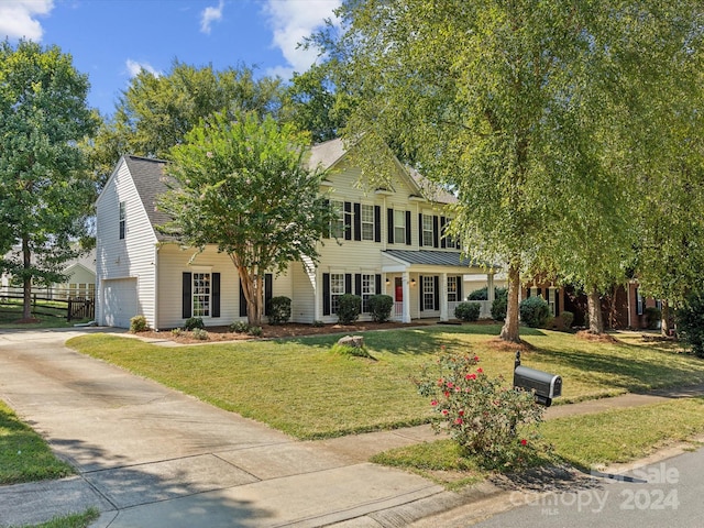 view of front facade with a front lawn and a garage