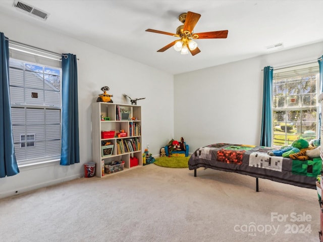 carpeted bedroom with ceiling fan