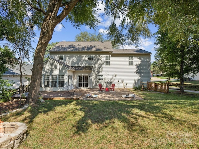 rear view of property with a patio area, a deck, and a lawn