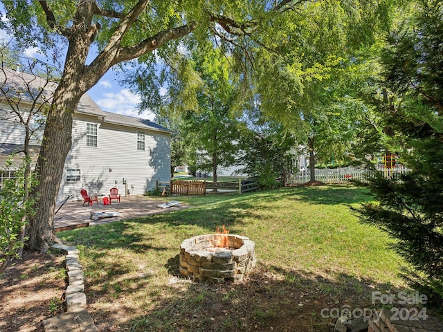 view of yard featuring a patio area and a fire pit