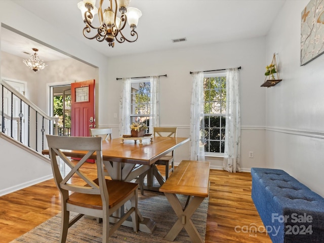 dining area with a chandelier and wood-type flooring