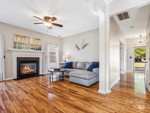 living room featuring ceiling fan and wood-type flooring