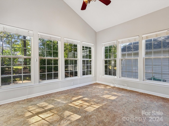 unfurnished sunroom featuring lofted ceiling, ceiling fan, and a wealth of natural light