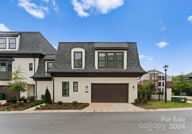 french country style house with a garage