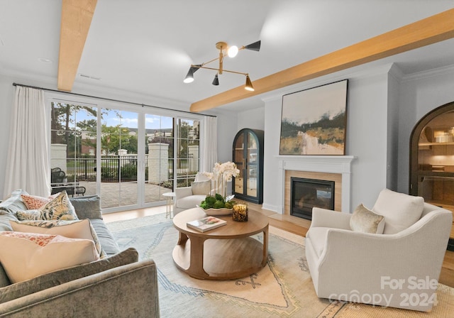 living room featuring light wood-type flooring, crown molding, and an inviting chandelier