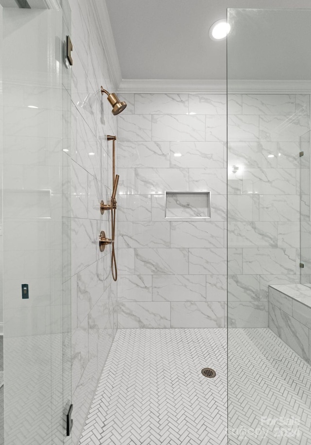 bathroom featuring ornamental molding and walk in shower