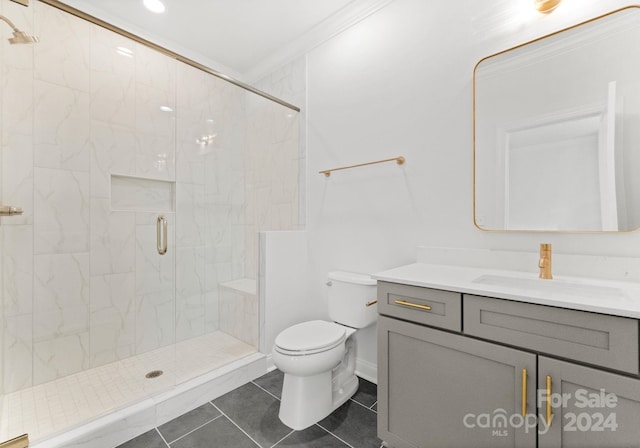 bathroom featuring vanity, an enclosed shower, tile patterned floors, crown molding, and toilet