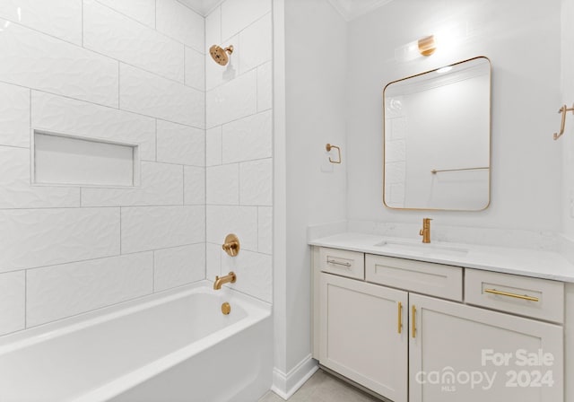 bathroom with tiled shower / bath combo and vanity