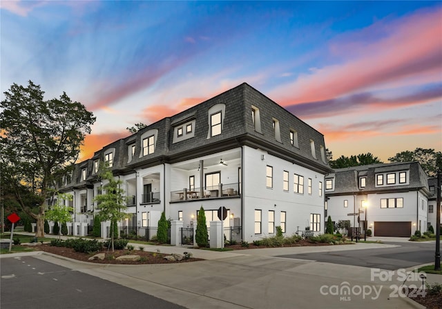 outdoor building at dusk with a garage