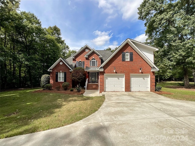 view of front of property featuring a garage and a front yard