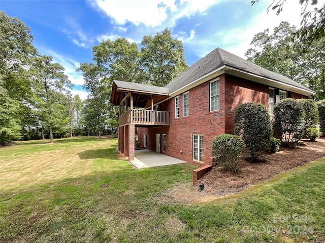 back of property featuring a lawn and a patio