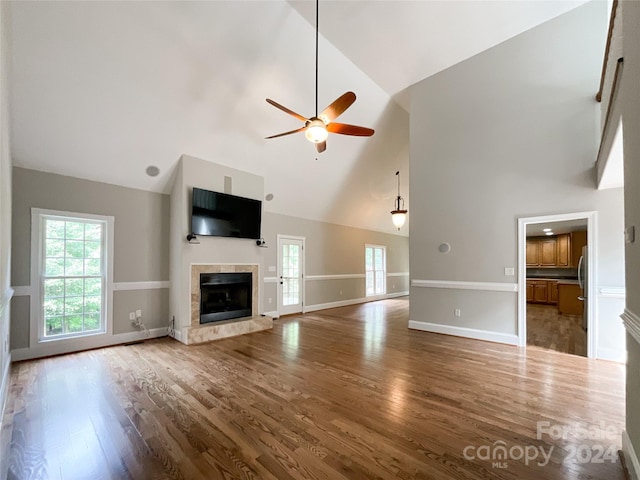 2510 Doster Rd, Monroe, NC 28112 - unfurnished living room with wood finished floors, a healthy amount of sunlight, a premium fireplace, and ceiling fan