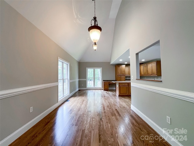 2510 Doster Rd, Monroe, NC 28112 - unfurnished living room with baseboards, high vaulted ceiling, and wood finished floors