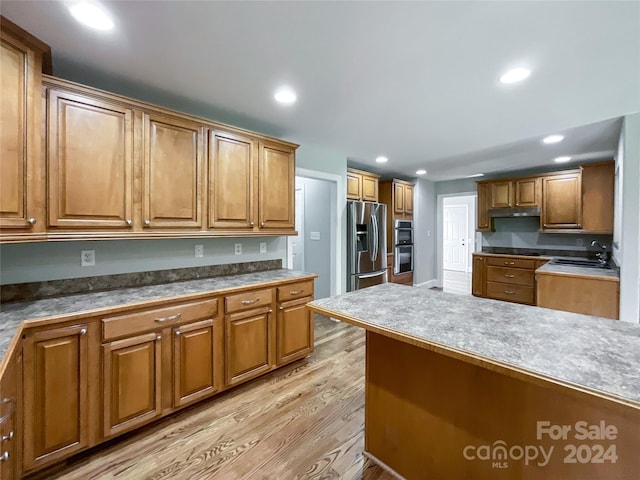 2510 Doster Rd, Monroe, NC 28112 - kitchen with light wood-style flooring, stainless steel fridge, brown cabinets, recessed lighting, and a sink