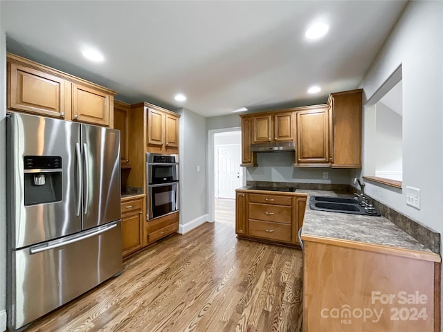 2510 Doster Rd, Monroe, NC 28112 - kitchen featuring a sink, under cabinet range hood, stainless steel appliances, light wood-style floors, and recessed lighting